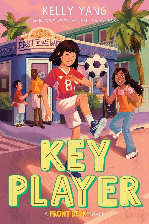 a young chinese girl is wearing a red soccer top and white shorts and is bouncing a soccer ball on her knee.