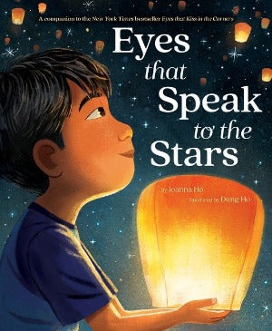 A young asian boy holding a beautiful orange glowing lantern