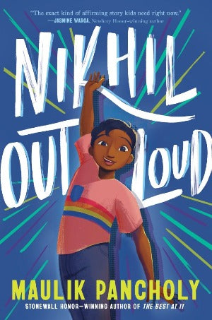 a 13 year old boy with brown skin and smooth black hair is standing with one hand raised and the other hand down as if performing. He is wearing a pink t-shirt with rainbow stripes.