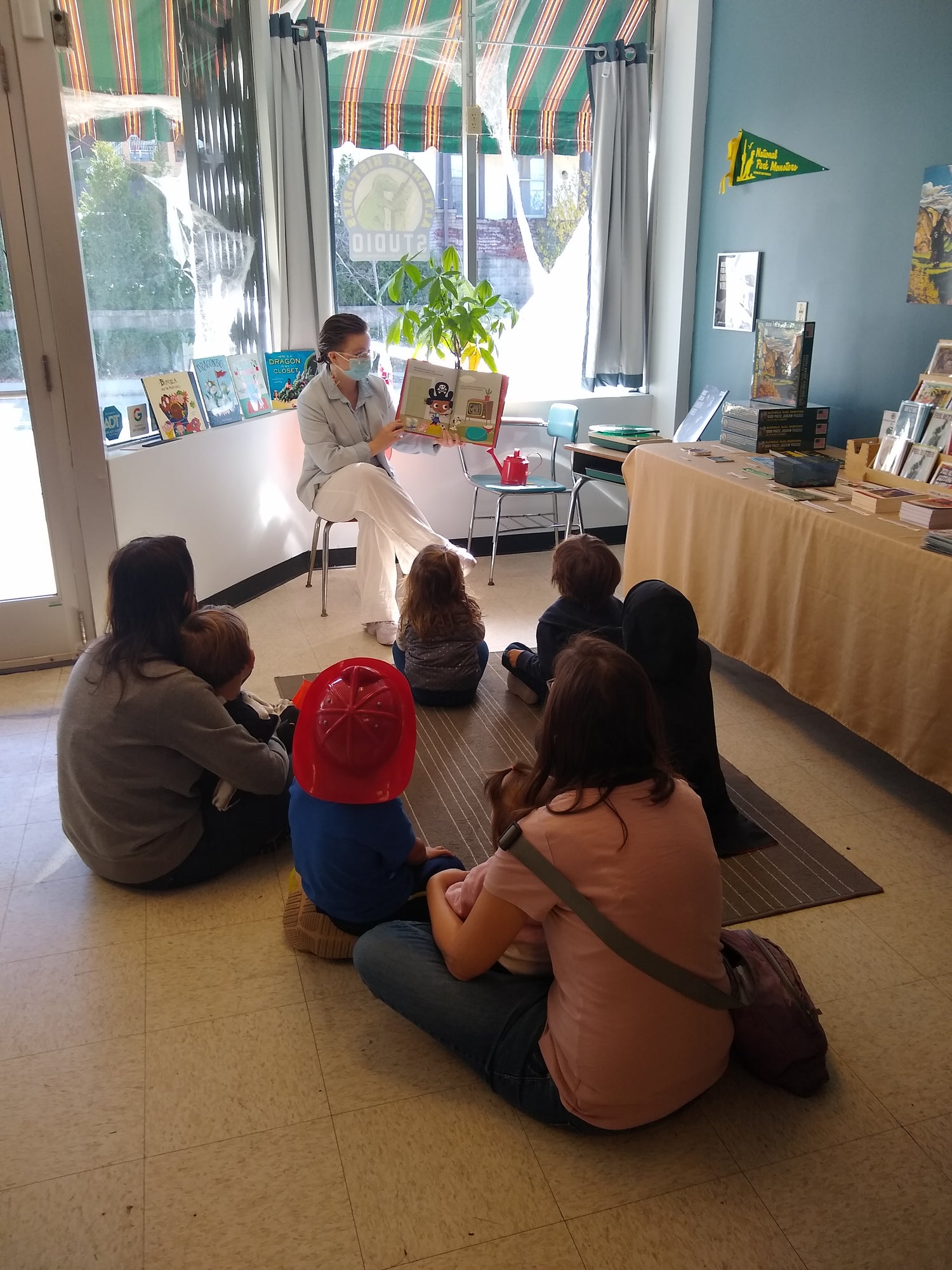 Elsie reading a book to some families