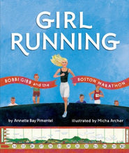 a young woman with blond hair running towards a finish tape in a race