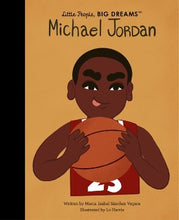 a young African American boy holding a basketball