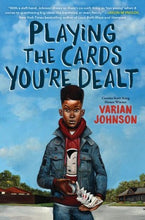 A young Black Boy shuffling cards