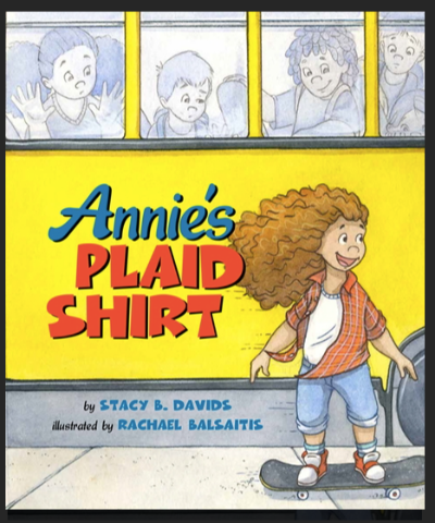 Young girl with long wavy hair wearing plaid shirt riding a skateboard