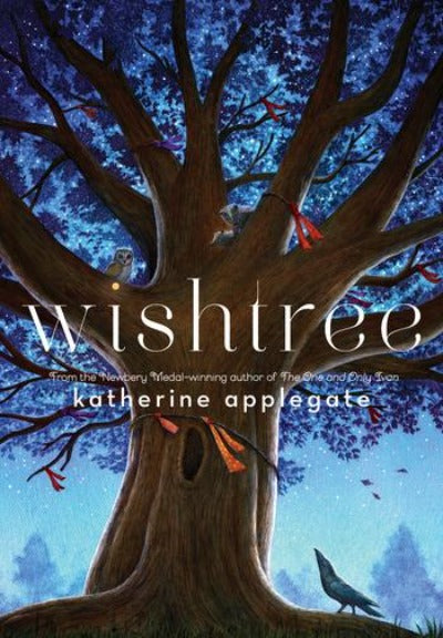 A majestic tree with red ribbons tied to branches