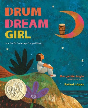 a young girl is sitting on a hill at the edge of the water looking up at an orange crescent moon with a drum inside it