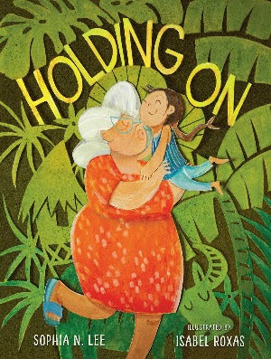 a grandmother with white hair, glasses and wearing an orange dress is holding up a young girl. They are furrounded by lush foliage.