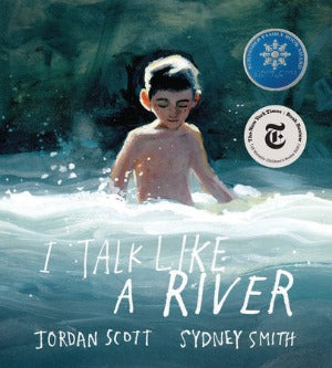 a young boy is waist high in the river rapids which are swirling around him