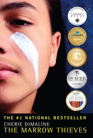 half of the face of a teen native boy is shown with a white stripe down his cheek and his long black hair.