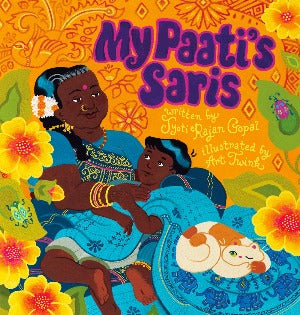 a young Tamil boy is sitting on his grandmother's lap and they are covere din her beautiful turquoise blue sari