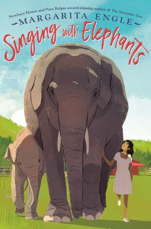 a young girl is walking next to an elephant momma and her baby.