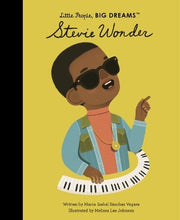 a young Stevie Wonder wearing his sunglasses and at a keyboard
